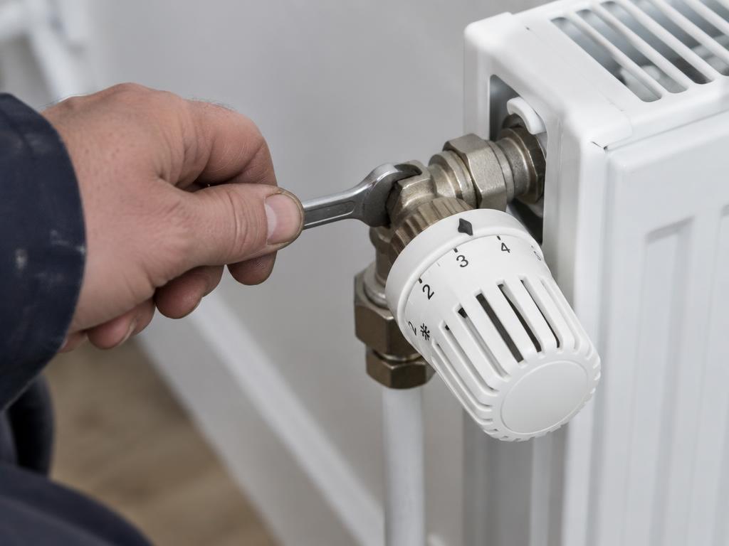 Engineer adjusting a radiator valve